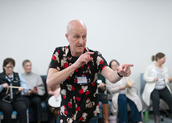 Tim Steiner from the Royal Philharmonic Orchestra directs stroke survivors, UCI medical staff and musicians in a unique musical performance.